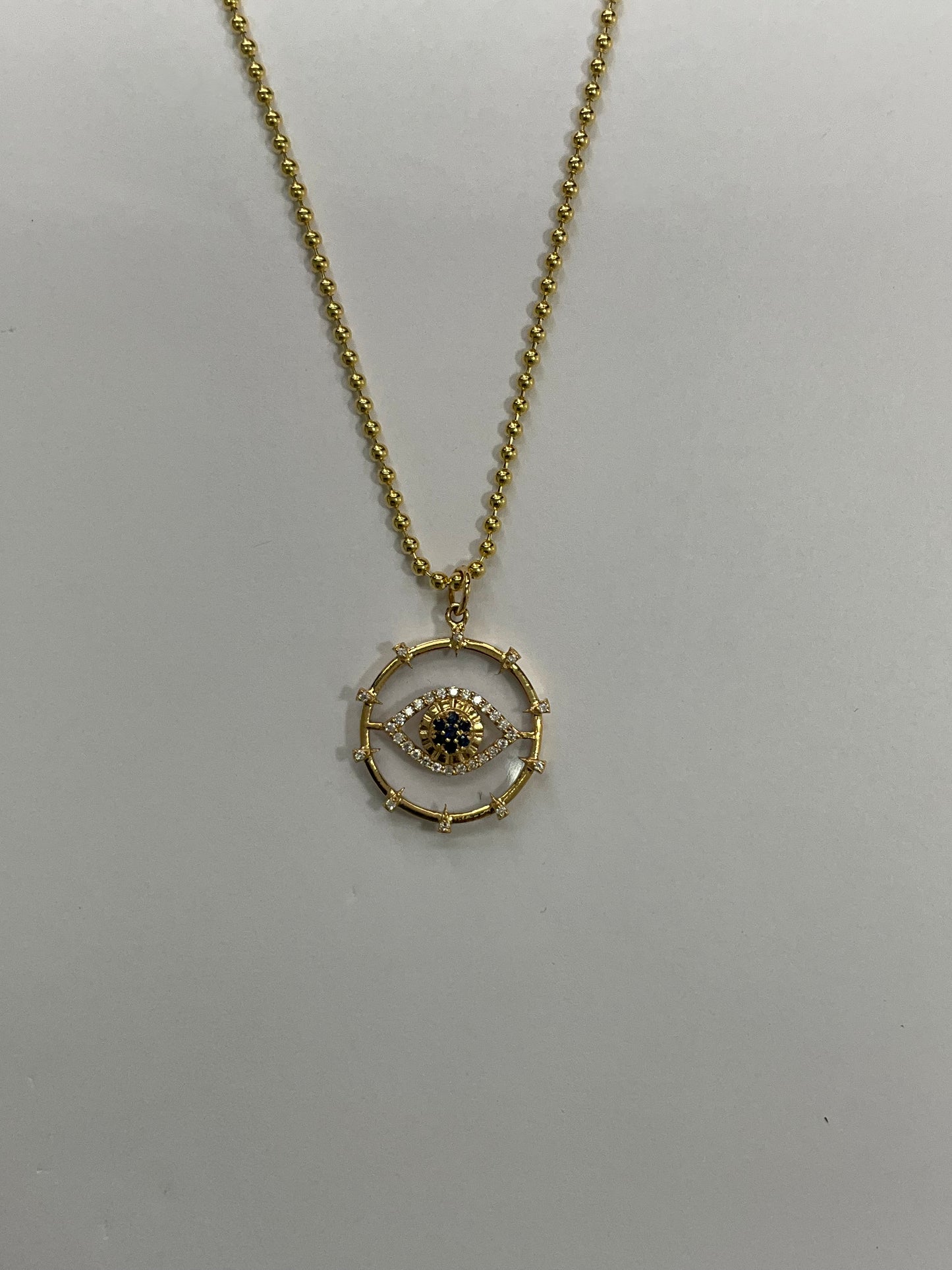 14KY Gold Round Clear Quartz Evil Eye Medallion Pendant with Diamonds And Sapphire